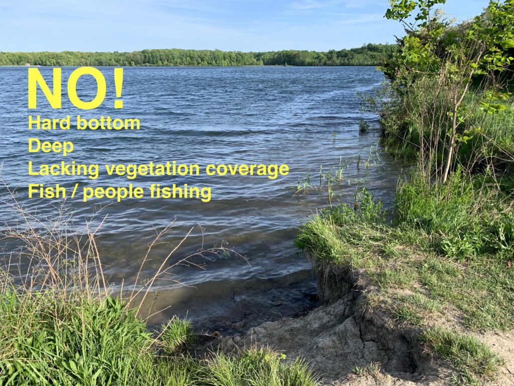 A photograph of a reservoir of deep, open water with a hard bottom and not much vegetation. The word 'no" is written on the photo.