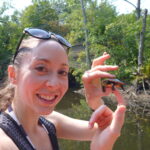 A Turtle Rescue League volunteer with a turtle she helped across a street.